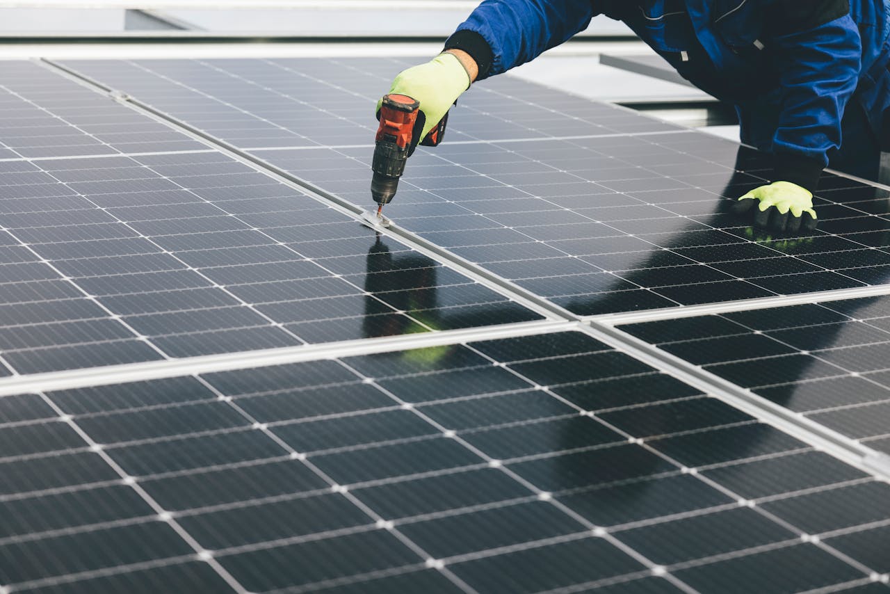 Crafting Captivating Headlines: Your awesome post title goes here A technician uses a power tool to install solar panels, showcasing renewable energy efforts.
